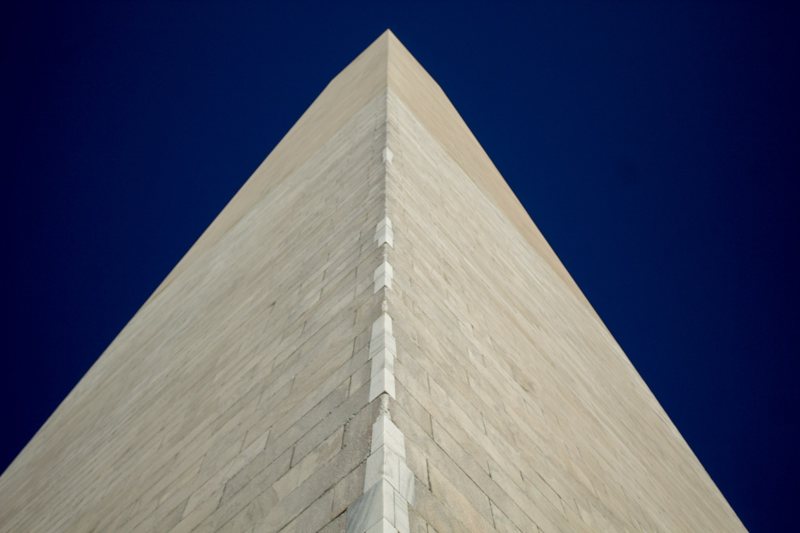 Washington Monument tip against deep blue sky
