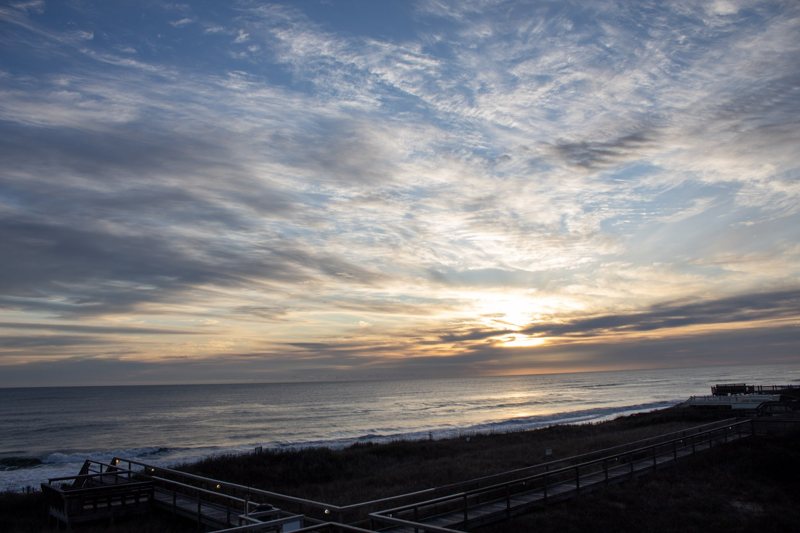 Sunset rays through clouds over the ocean