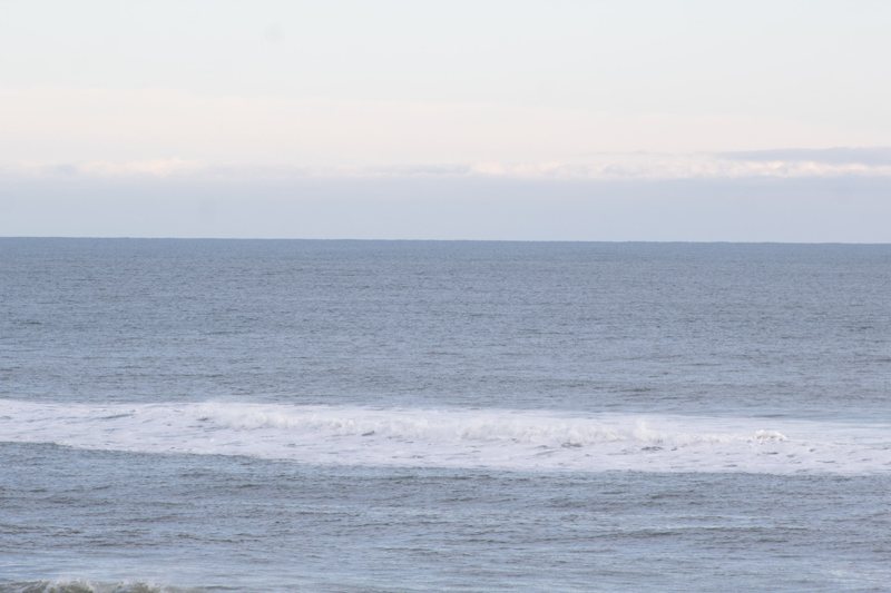 Minimal seascape with a soft breaking wave